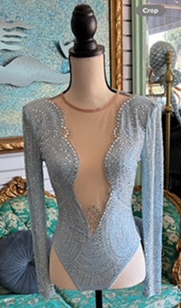 A mannequin wearing a dress with long sleeves.