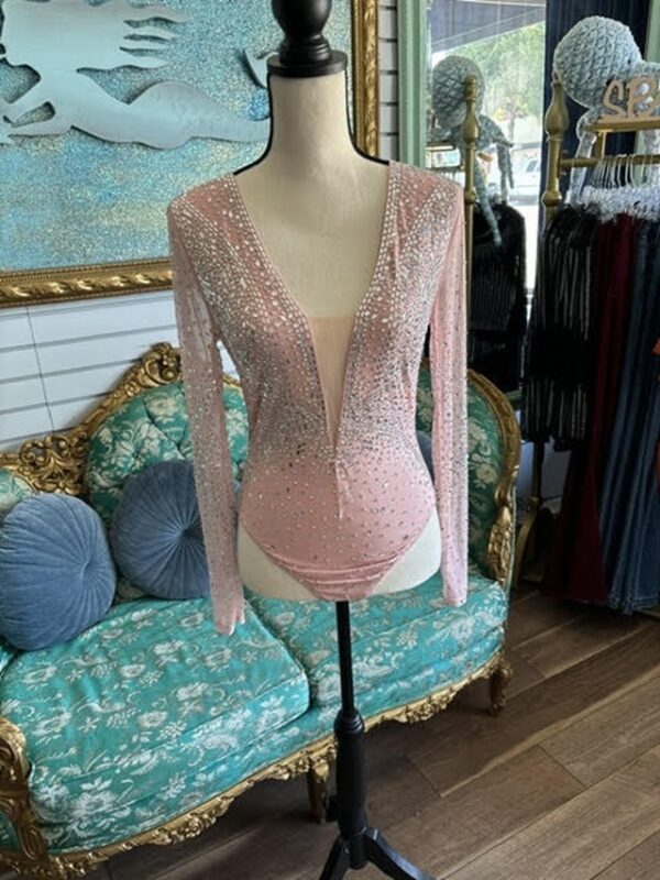 A mannequin wearing a pink bodysuit with lace.