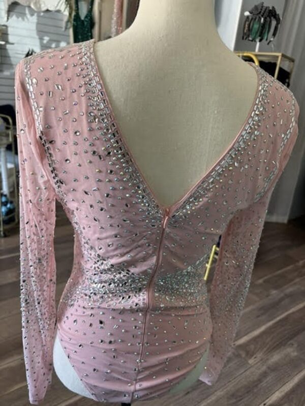 A pink dress with silver and white dots on it